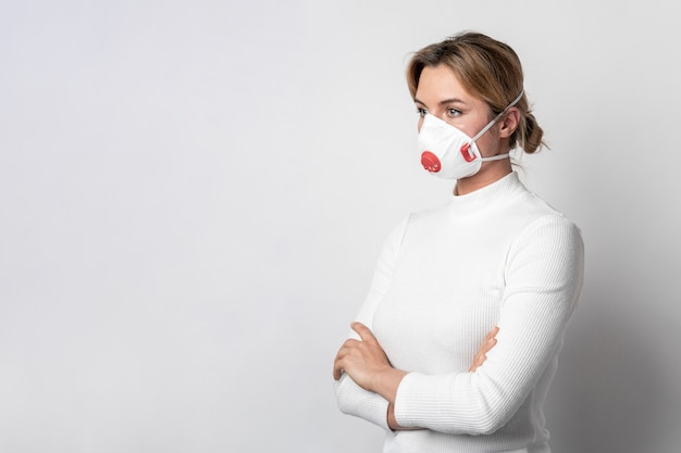 Portrait of young woman posing with surgical mask