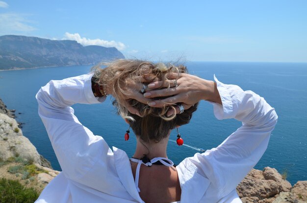 Portrait of young woman in sea against sky