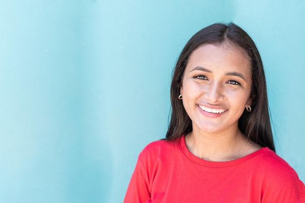 Portrait of young woman smiling in the street