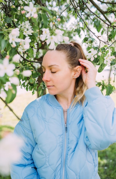 Portrait of a young woman in spring in a park