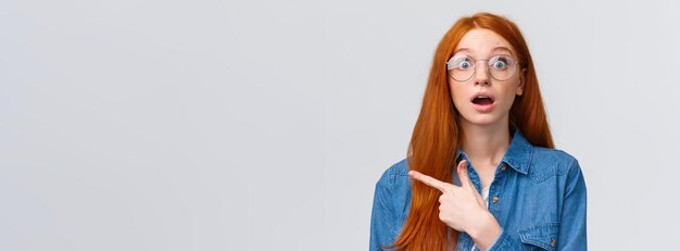 Portrait of young woman standing against white background