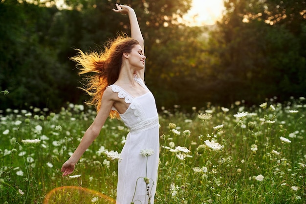 Portrait of young woman standing on field