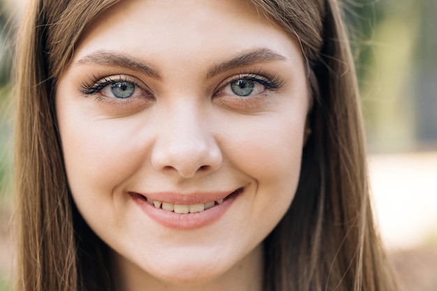 Portrait young woman at sunlight with long hair open eyes look at camera smiling fashion model femal