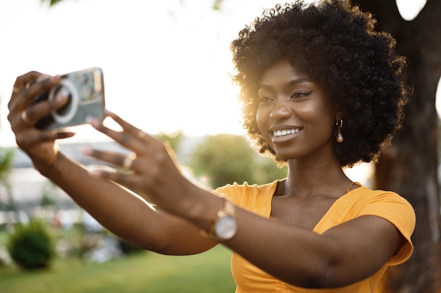 Portrait of a young woman taking a selfie outdoor