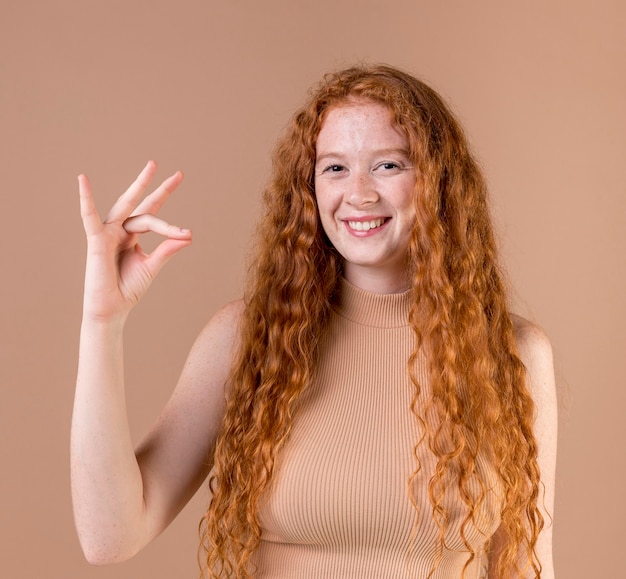 Portrait of a young woman teaching sign language