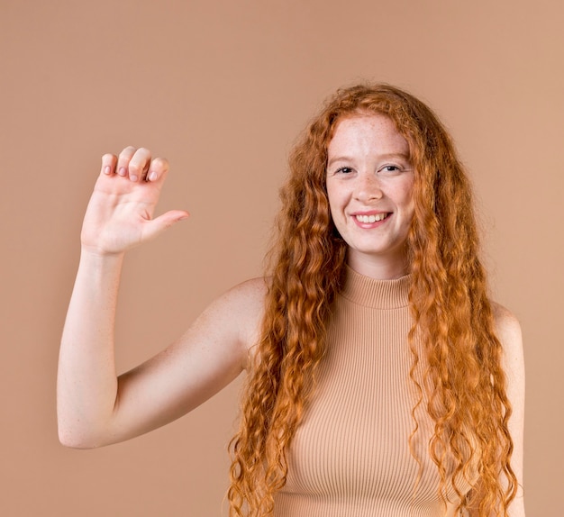 Portrait of a young woman teaching sign language