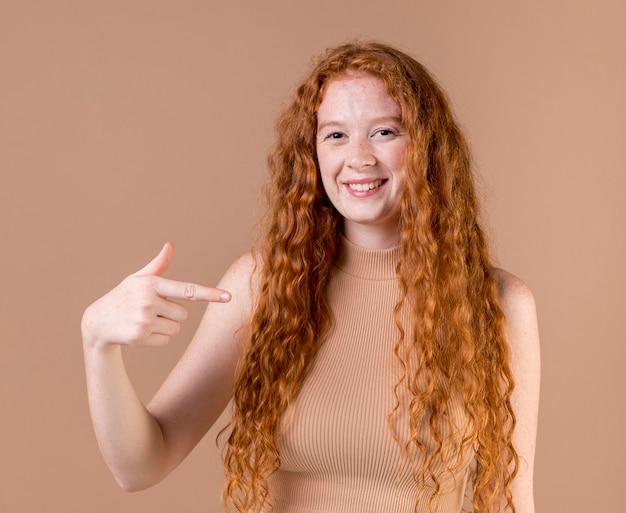 Portrait of a young woman teaching sign language