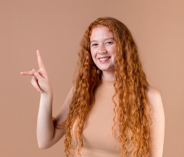 Portrait of a young woman teaching sign language