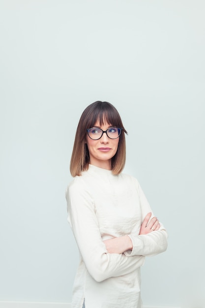 Portrait of young woman wearing eyeglasses in office