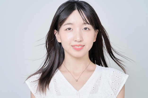 Portrait of young woman and white background