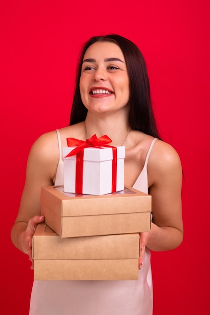 Portrait of a young woman with boxes of gifts for the holiday Christmas and New Year