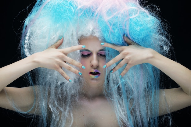 portrait of  a young woman with bright make up and creative hair