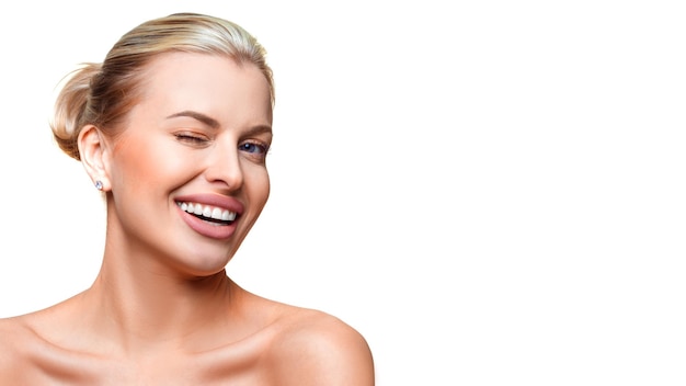 Portrait of a young woman with clear fresh skin winking isolated on white background