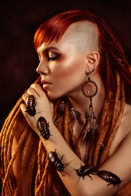 Portrait of a young woman with cockroaches on her face