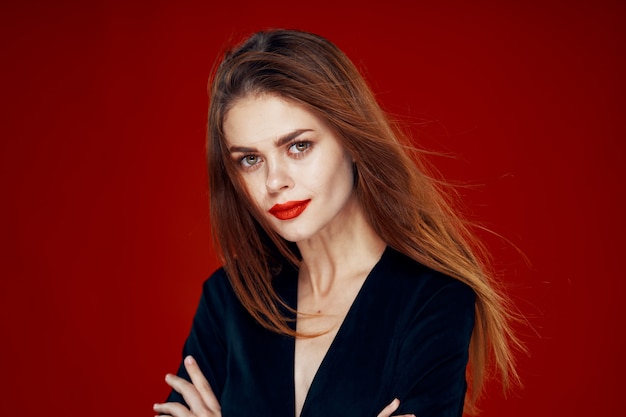 Portrait of a young woman with flying hair on a red background