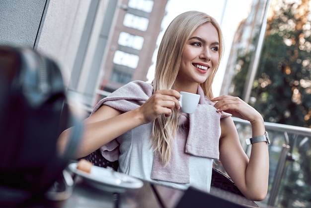 Portrait young woman with glasses drinking coffee in cafe relax