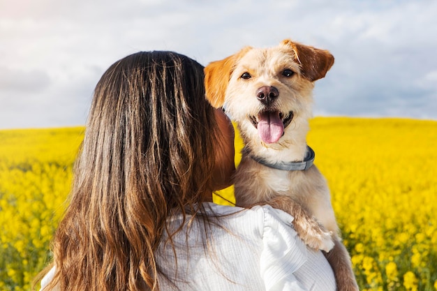 Portrait young woman with happy dog nature background