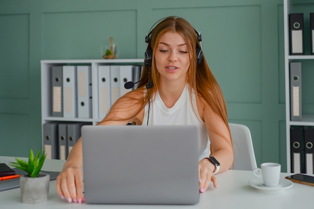 portrait of young woman with laptop freelancer working