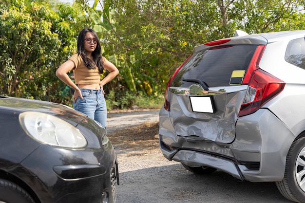 Portrait of young woman with scratched car at parking Standing and watching the car that was hit until the car collapsed show heart symptoms