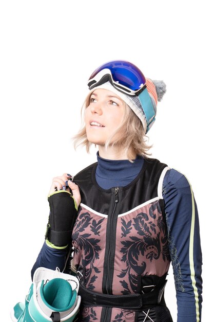 Photo portrait of a young woman with snowboard boots and glasses