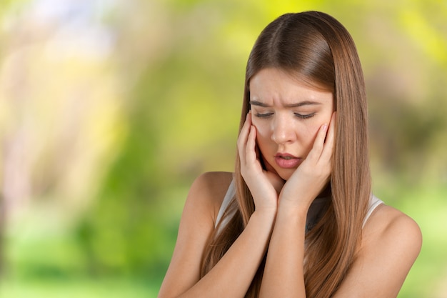 Portrait of young woman with toothache