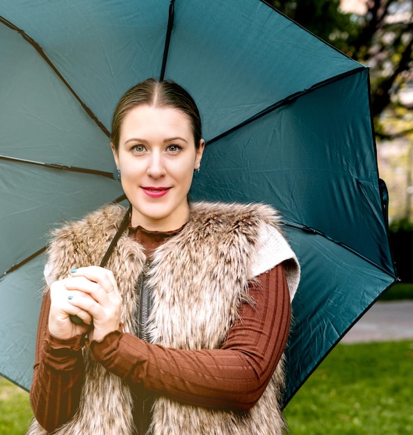 Portrait of young woman with an umbrella