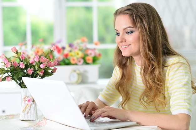 Portrait of young woman working with laptop