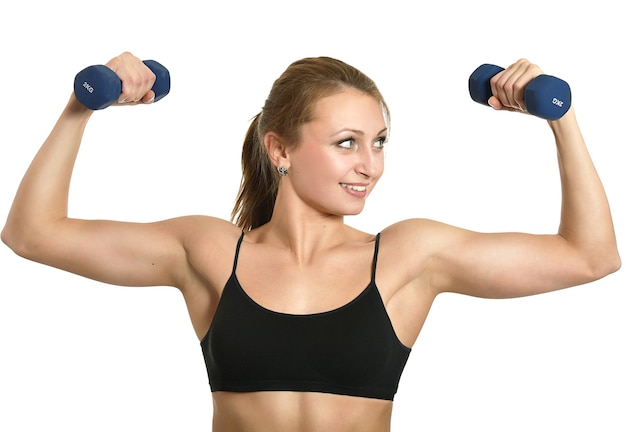 Portrait of young woman workout with dumbbells on white