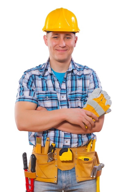 Portrait of young worker with crossed arms holding protective gloves smiling and looking at camera isolated