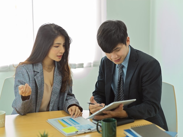 Portraits of businesspeople talking to each other to consult on their work in office room