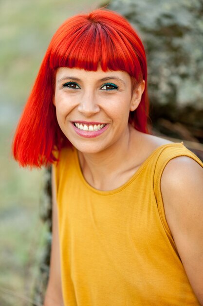 Portratif of red haired woman relaxed in a park