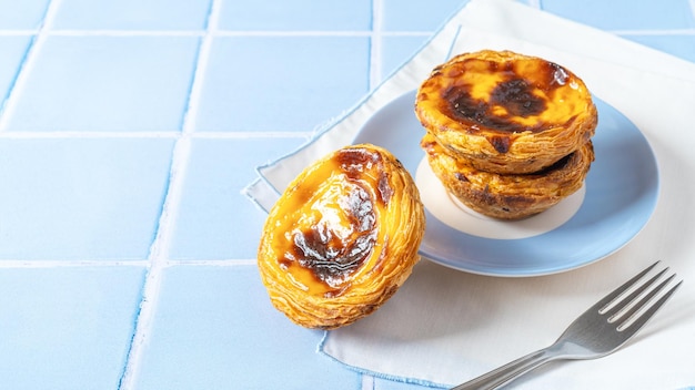 Portuguese dessert Pastel de nata on blue tile