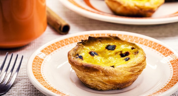 Portuguese Pastel de Nata called Pastel de Belem traditional Portuguese delicacy made with eggs cinnamon and caramel