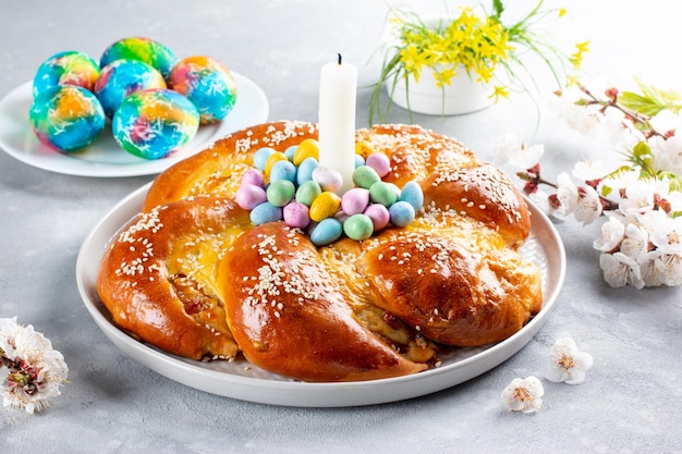 Portuguese traditional Easter cake Folar with eggs on wooden table