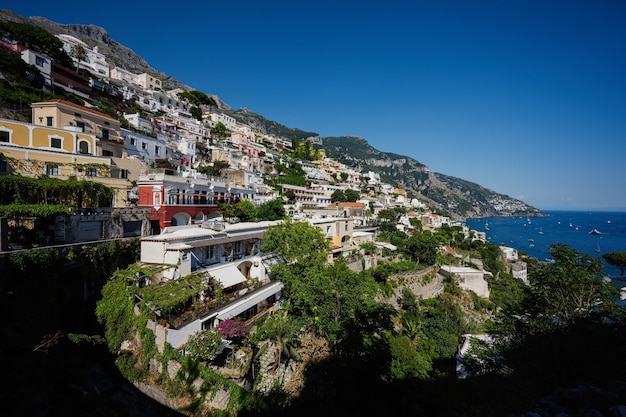 Positano with hotels and houses on hills leading down to coast comfortable beaches and azure sea on Amalfi Coast in Campania Italy