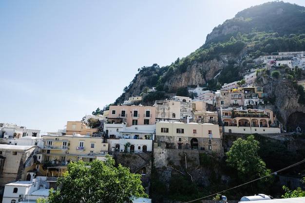 Positano with hotels and houses on hills leading down to coast comfortable beaches and azure sea on Amalfi Coast in Campania Italy