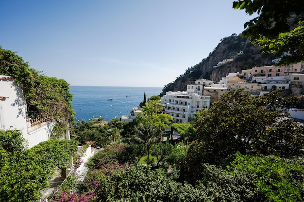 Positano with hotels and houses on hills leading down to coast comfortable beaches and azure sea on Amalfi Coast in Campania Italy