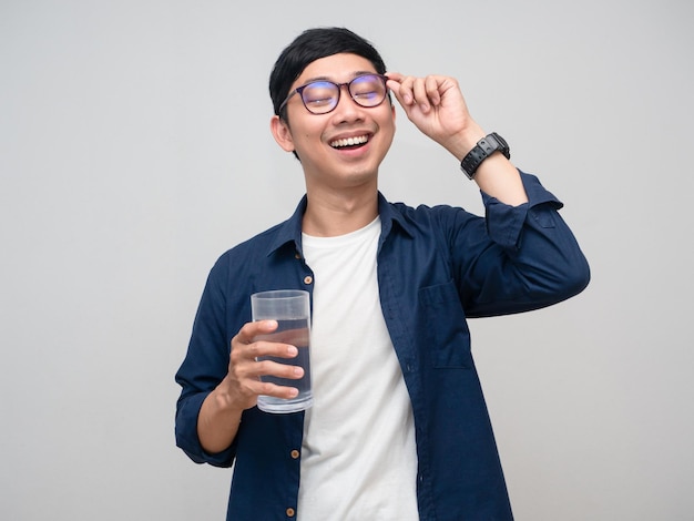 Positive asian man feels fresh with drinking water in hand isolated