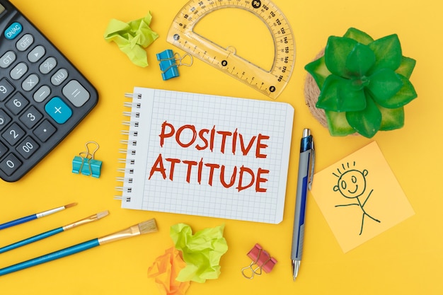 Positive Attitude. Inspirational quotes on notebook and office supplies