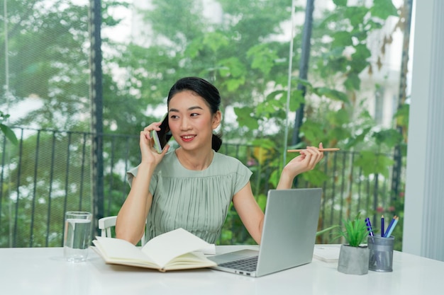 Positive beautiful woman talking on cell phone