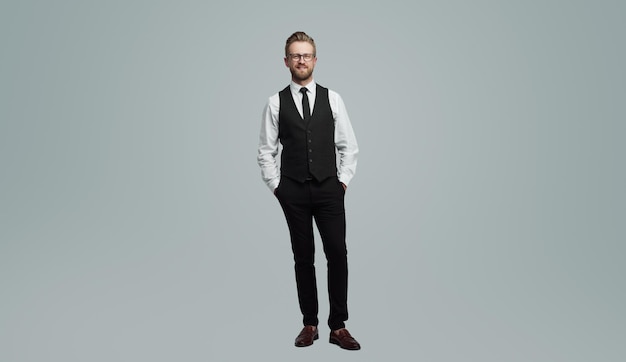 Positive businessman with hands in pockets