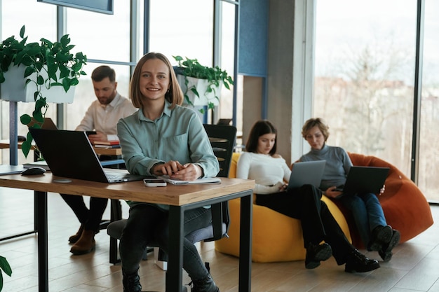 Positive and cheerful mood People are working in the office with bean bags chairs in it