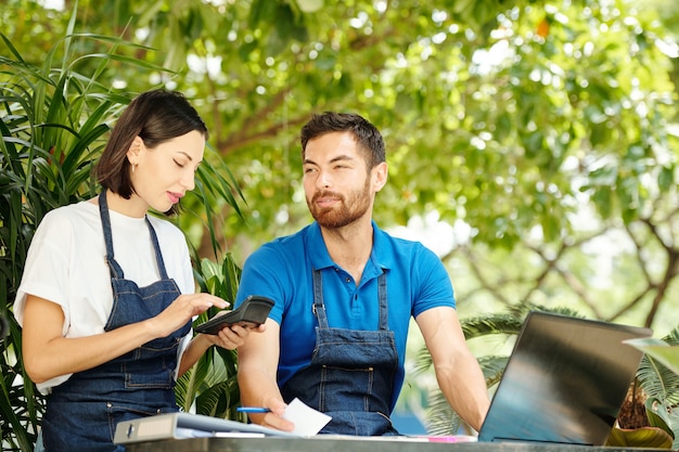 Positive coffeeshop owners calculating earnings and expances and planning work during pandemic crisis