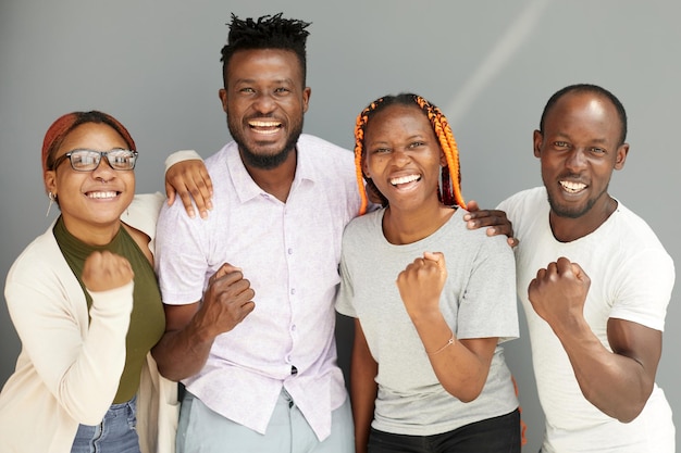 Positive corporate team posing while looking at the camera