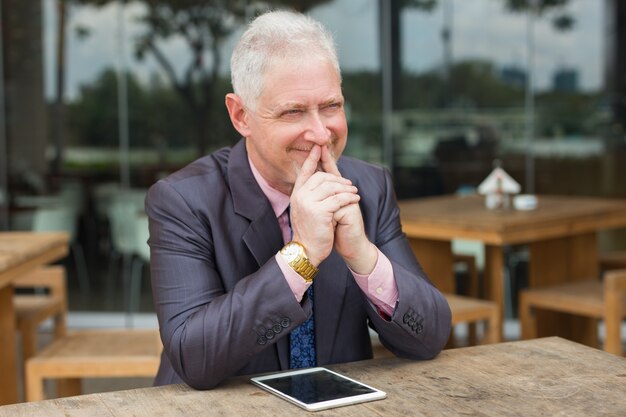 Positive Entrepreneur with Tablet in Street Cafe