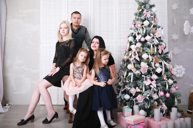 Positive family meeting at home interior and celebrating Christmas togetherChristmas Family with Kids opening Christmas gifts Christmas Tree