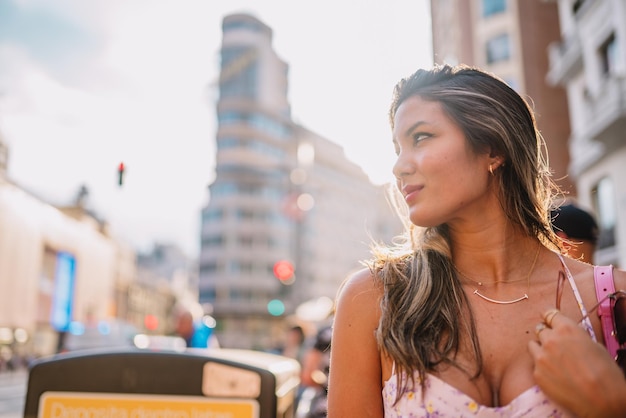 Positive female tourist on street of Madrid city Spain and shooting on camera