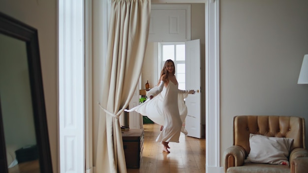 Positive girl relaxing at cozy house alone Dancing woman enjoying weekend