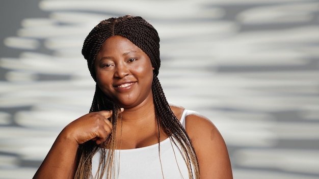 Positive girl with natural radiant skin posing in studio