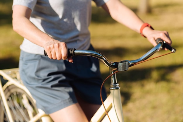 Positive granddaughter and her grandmother in the park riding bicycles